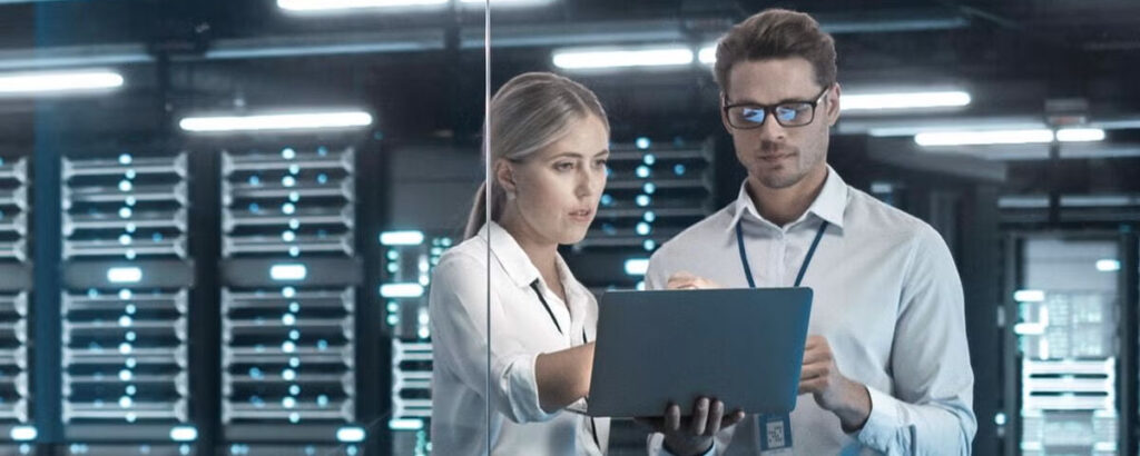 Two IT Engineers Standing in Working Data Center